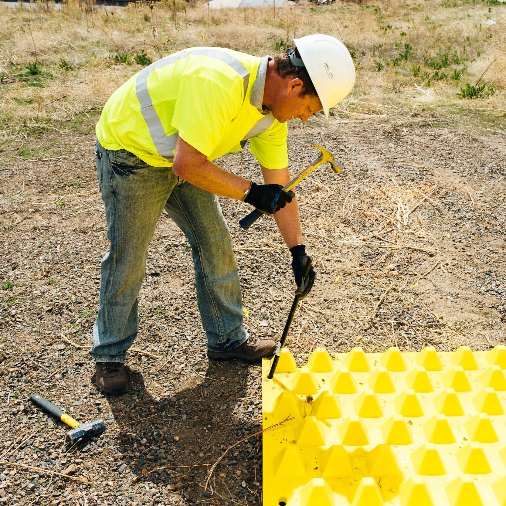 FODS Trackout Control Mat Installing Over Dirt With Round Head Stake